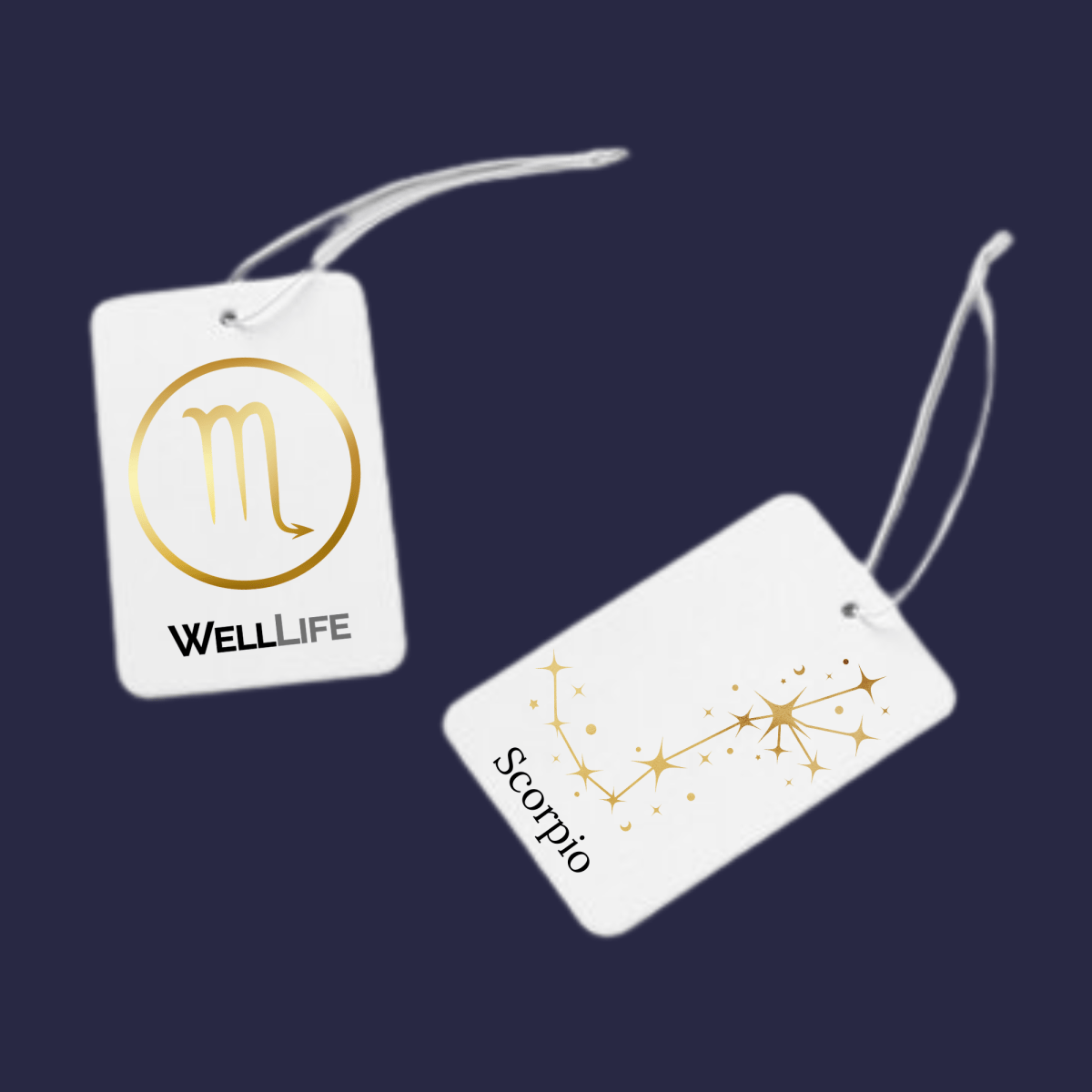 Two white tags with goldodiac symbols and 'WELL LIFE' branding on a dark blue background